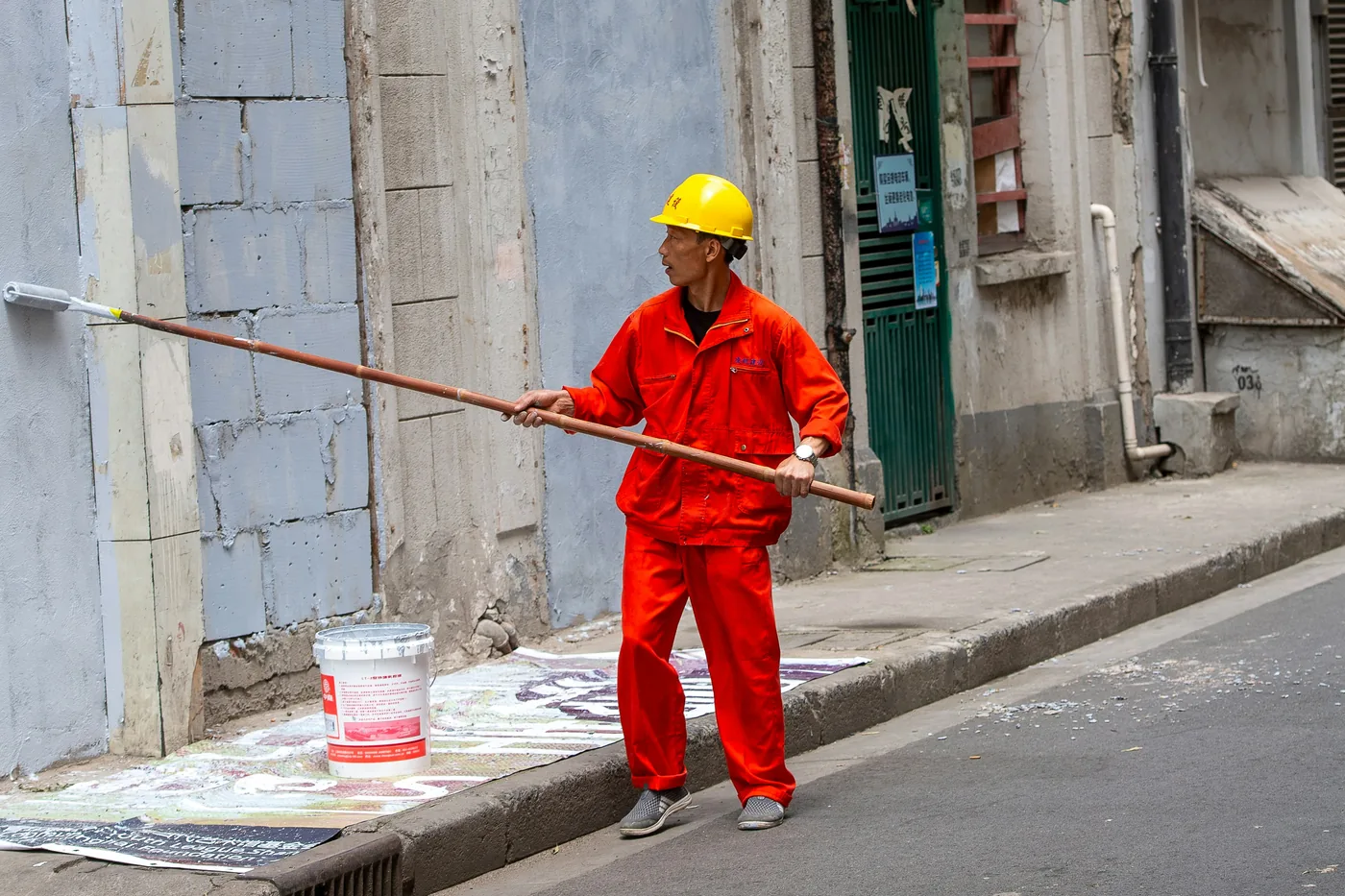 Construction worker painting an exterior wall
